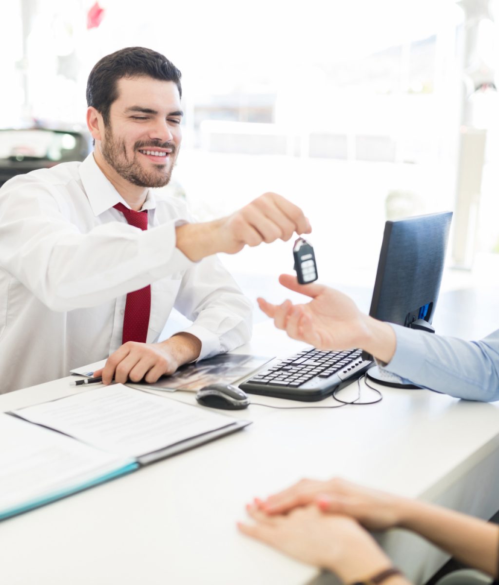 sales-expert-passing-new-car-keys-to-customers-2025-06-09-11-30-47-utc-1-1500x1000